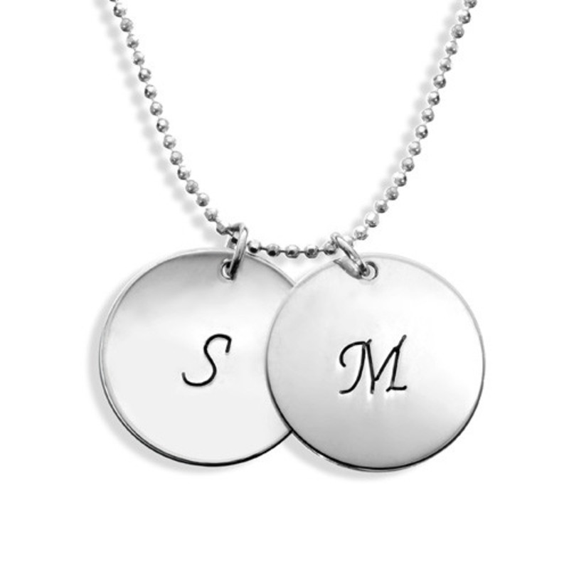 The Sterling Silver Initial Disc Necklace is a sophisticated take on person...